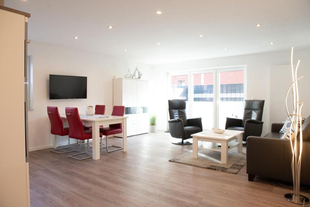 a living room with a table and chairs at Deichnähe - G in Norddeich