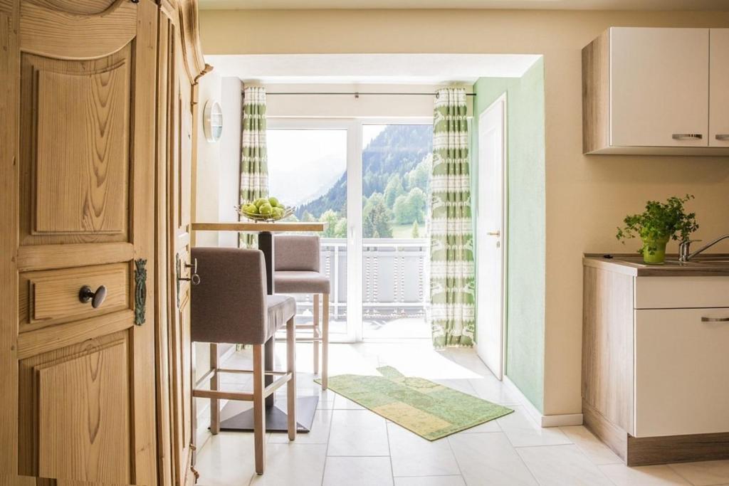 a kitchen and dining room with a view of a mountain at Wildgrün Mini Lodge 8a in Pfronten