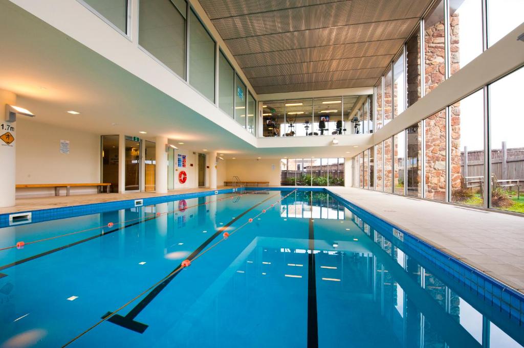 an empty swimming pool in a building at Wyndham Resort Torquay in Torquay