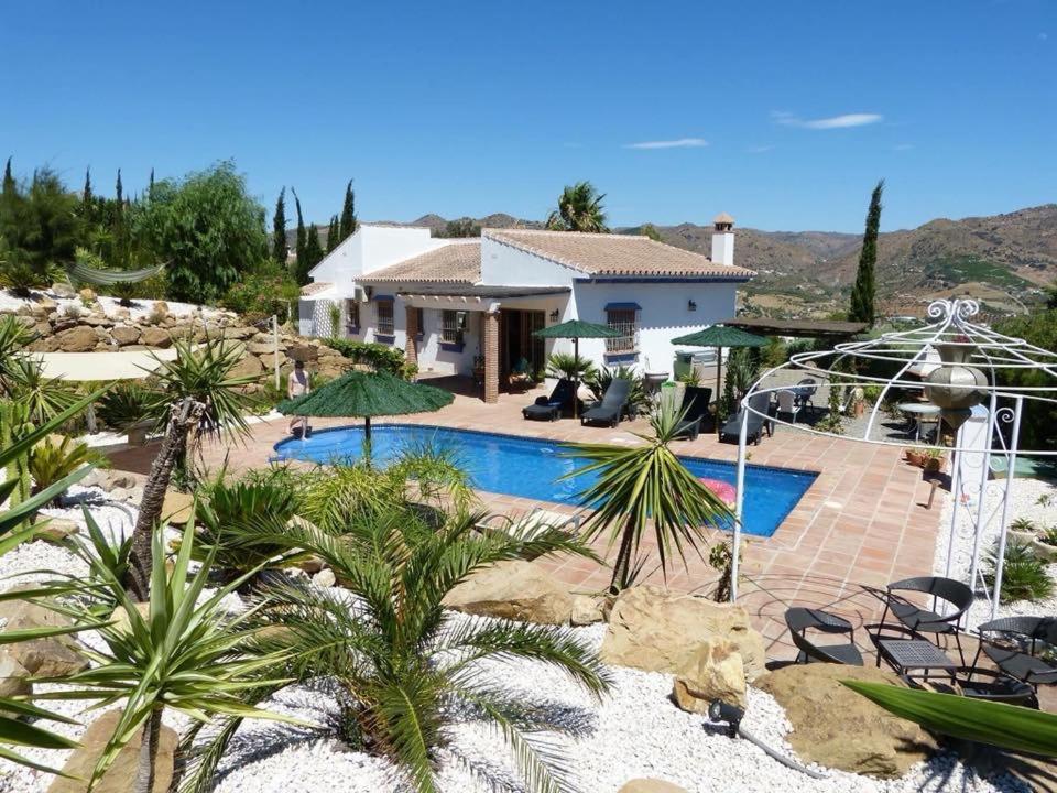 a villa with a swimming pool and a house at Casa Mimosa Álora in Alora