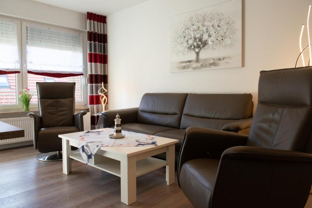 a living room with a couch and a table at Florence in Norden