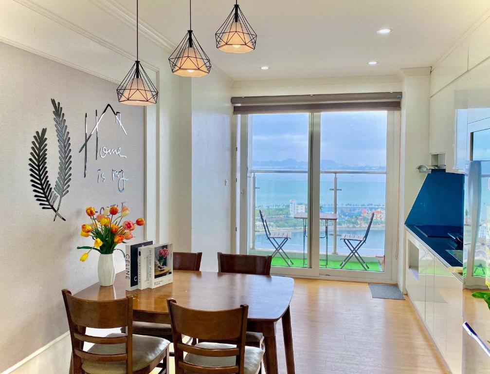 Un comedor con mesa y vista al mar. en Homestay Bãi Cháy HaLong 1 2 3 5 phòng ngủ Liên hệ em tư vấn, en Ha Long