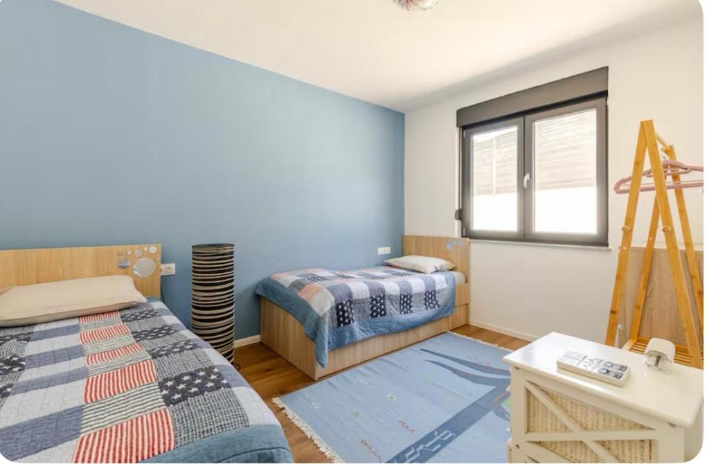 a bedroom with two beds and a window at Villa Mona with heated pool , modern comfort in Herzegovina in Mostar