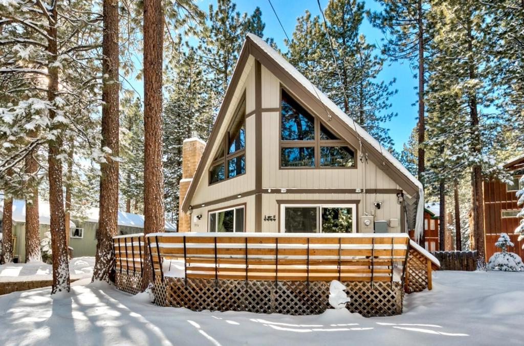 a house in the woods in the snow at Bear Chalet - Snow Play - 4 Bedrooms - Foosball in South Lake Tahoe