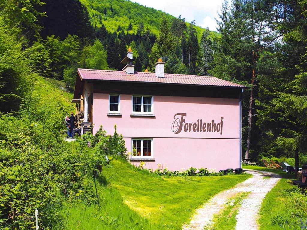 a pink house with a sign on the side of it at Apartment in Alsace with Private Terrace in Dabo