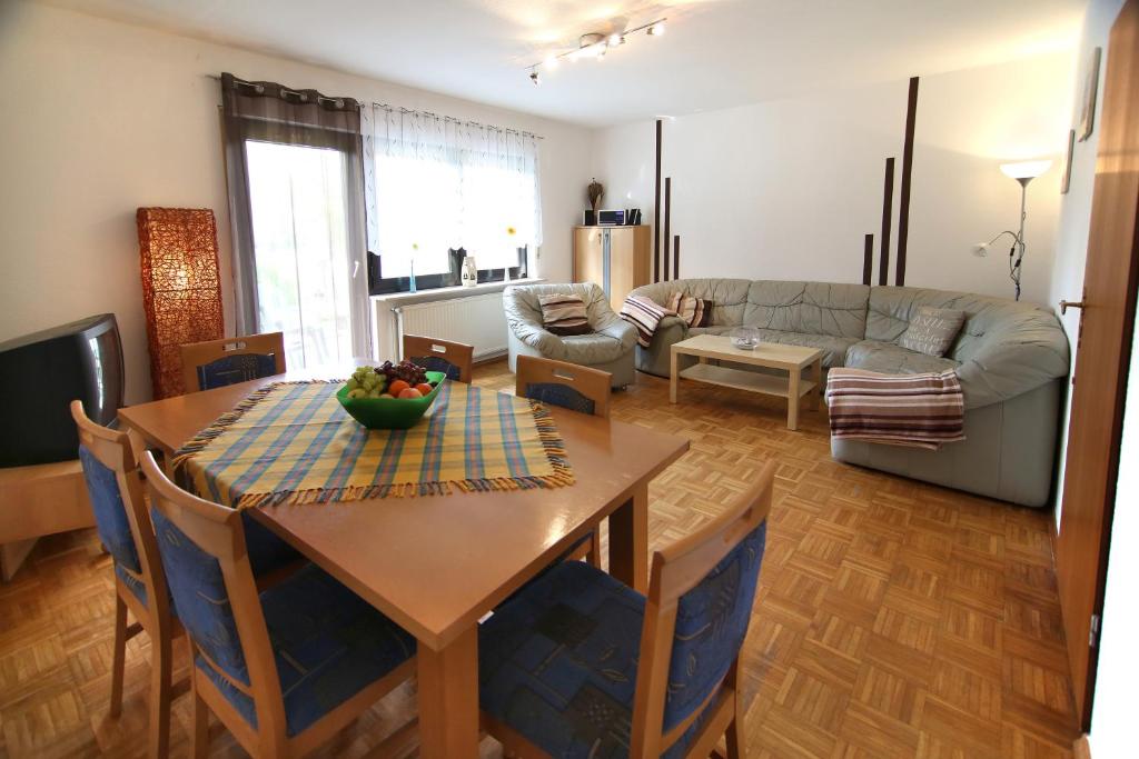 a living room with a table and a couch at Ferienhaus 43 in Burhave in Burhave