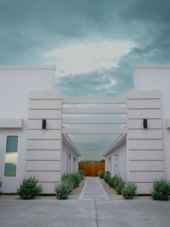 a row of white buildings in a parking lot at Premier Luxe Villa in Weslaco