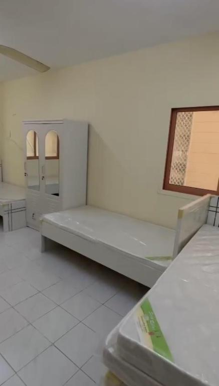 Voodi või voodid majutusasutuse Muscat Tower toas