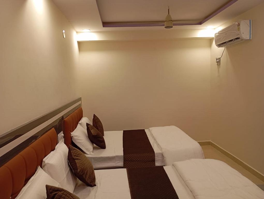 Postel nebo postele na pokoji v ubytování Aadya Inn New Luxury Hotel