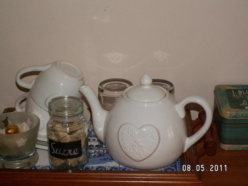 two white teapots sitting on top of a shelf at Chambre d&#39;hôtes - Dodo et tartines in Bayeux