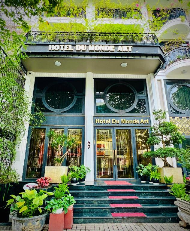 a hotel entrance with plants in front of it at Hotel du Monde Art in Hanoi