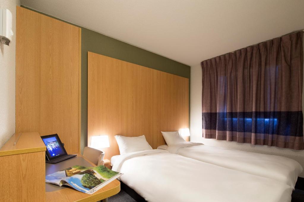 Postel nebo postele na pokoji v ubytování B&B HOTEL Castres Centre Gambetta