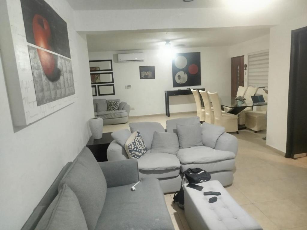 a living room with a couch and a table at Cancun in Cancún