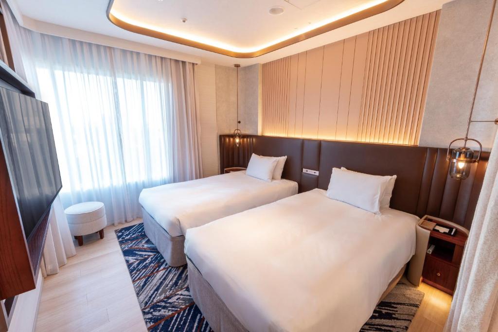 Postel nebo postele na pokoji v ubytování Hotel Springs Makuhari Premier