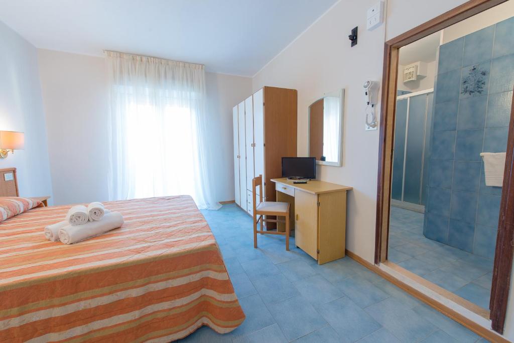Postel nebo postele na pokoji v ubytování Hotel Falco