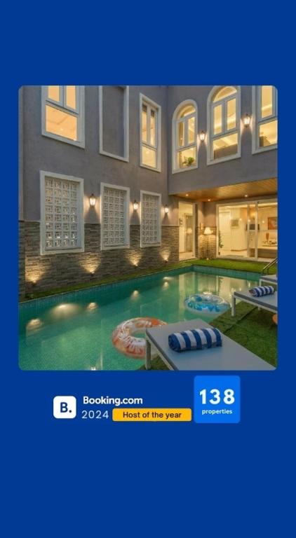 a picture of a house with a swimming pool at EKOSTAY - Grey Goose Villa in Calangute