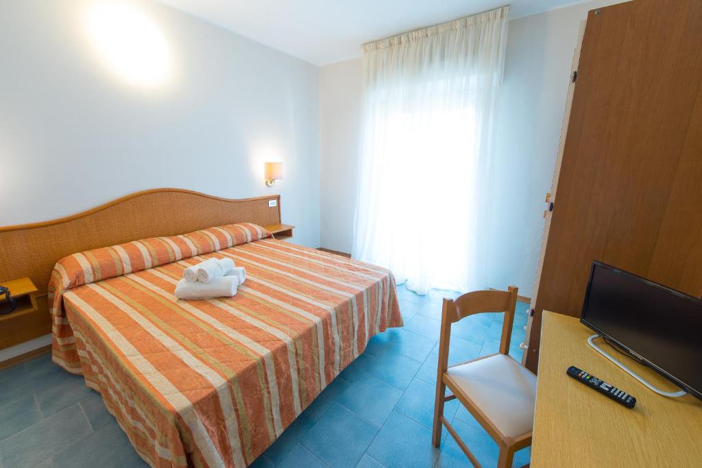 Postel nebo postele na pokoji v ubytování Hotel Falco