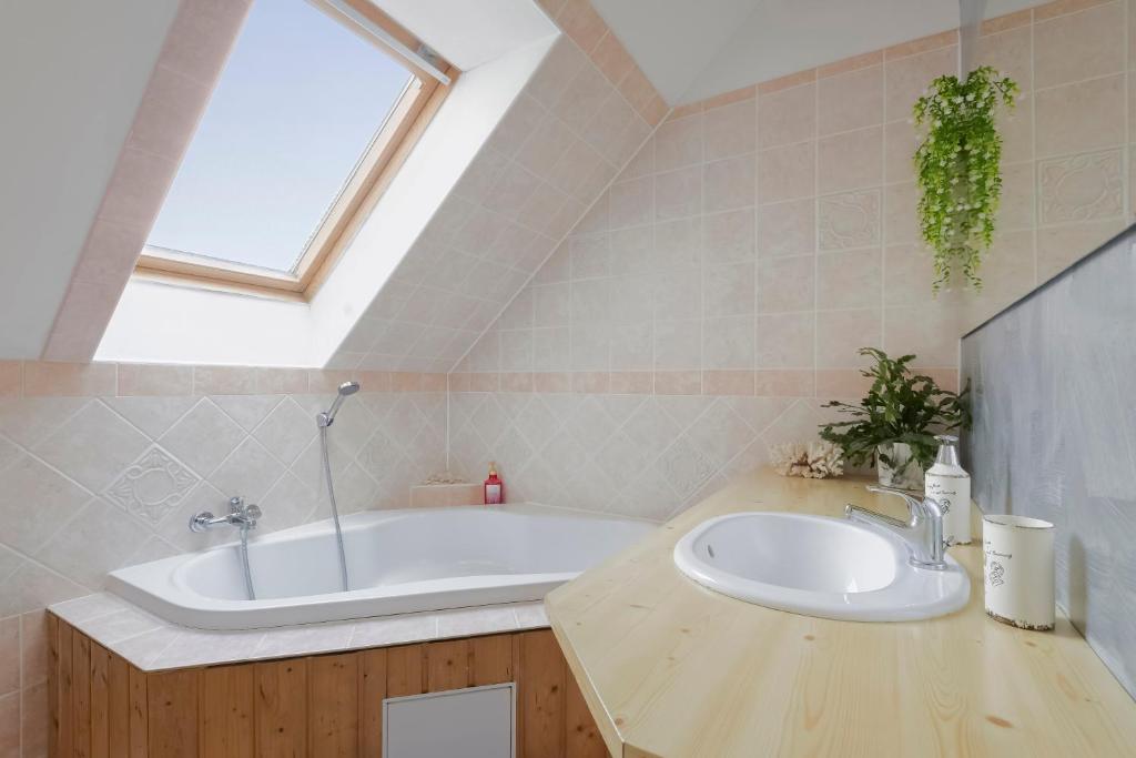 a bathroom with a sink and a bath tub at Guest House KRISTI in Tuchoměřice