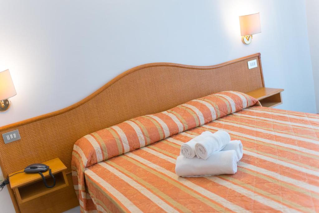 Postel nebo postele na pokoji v ubytování Hotel Falco