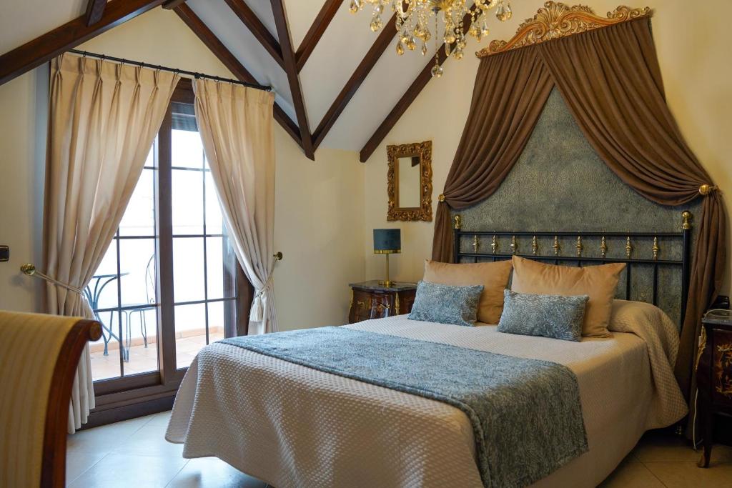 a bedroom with a large bed and a large window at Hotel Boutique Casa Veracruz in Estepona