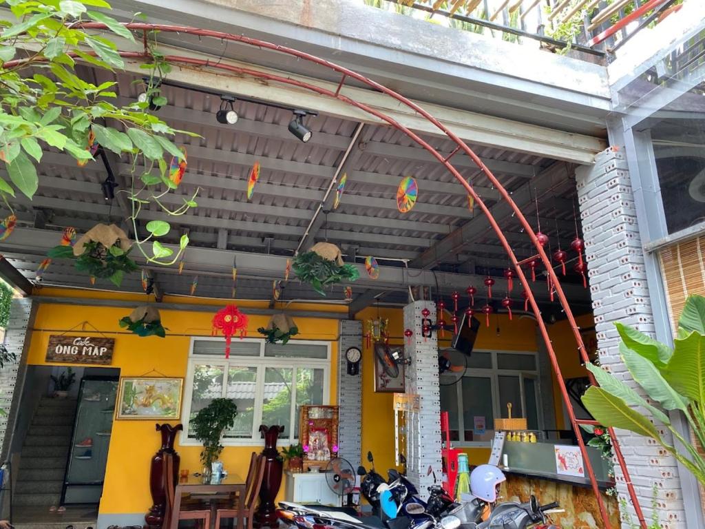 a restaurant with motorcycles parked outside of a building at Nature House Homestay in Ho Chi Minh City