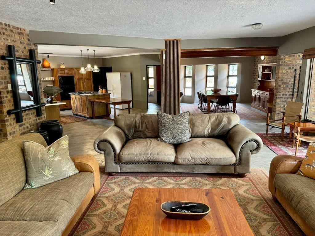 a living room with a couch and a table at Ukujabula in Groblersdal