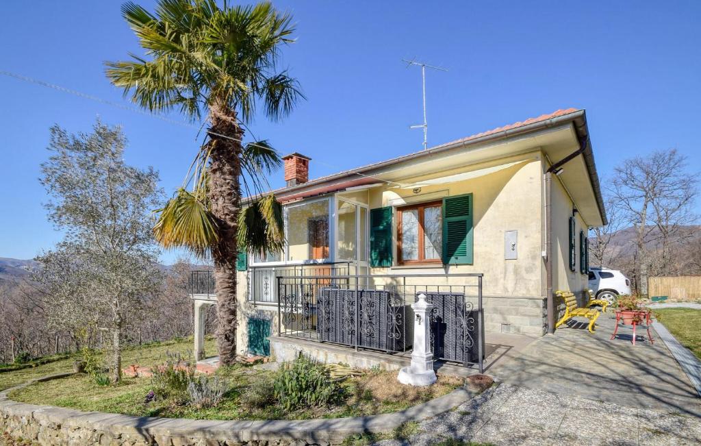 a house with a palm tree in front of it at Casa Lilly in Varese Ligure