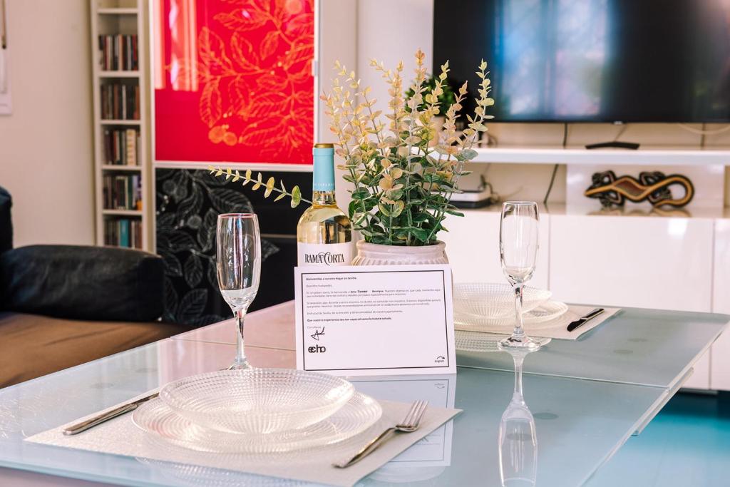 Hotel Echo Torneo Boutique, a table with two glasses and a bottle of wine at Echo Torneo Boutique in Seville