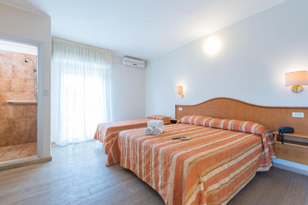 Postel nebo postele na pokoji v ubytování Hotel Falco
