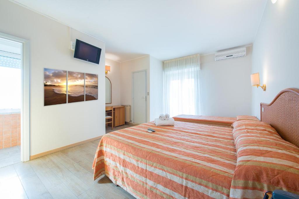 Postel nebo postele na pokoji v ubytování Hotel Falco