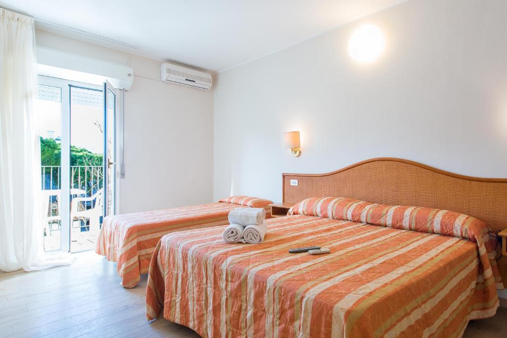 Postel nebo postele na pokoji v ubytování Hotel Falco