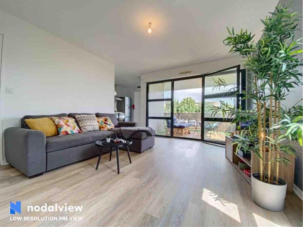 un salon avec un canapé et une table dans l'établissement Appartement au bord du lac, à Tours