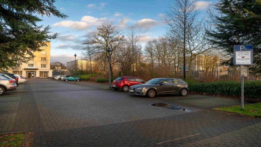a parking lot with cars parked on a street at Holiday Inn - the niu, Blade Solingen by IHG in Solingen