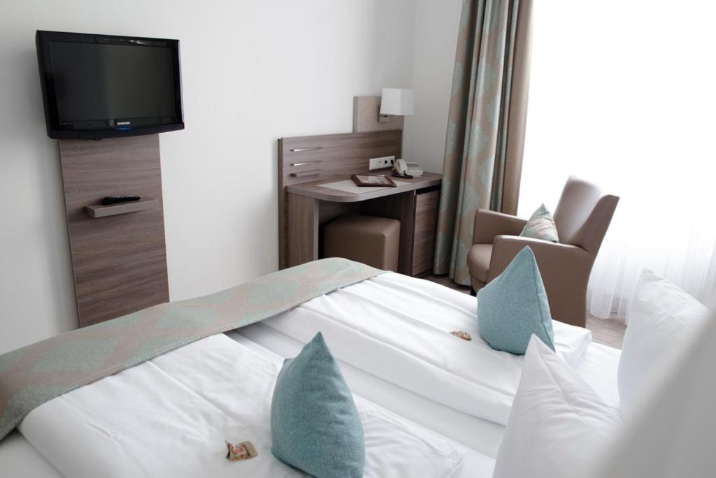 Postel nebo postele na pokoji v ubytování Heerens Hotel
