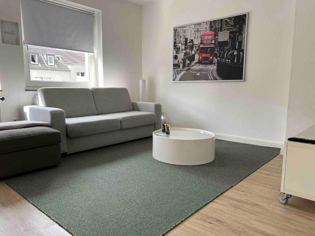 a living room with a couch and a coffee table at Wohnung mit Balkon am Rhein in Düsseldorf