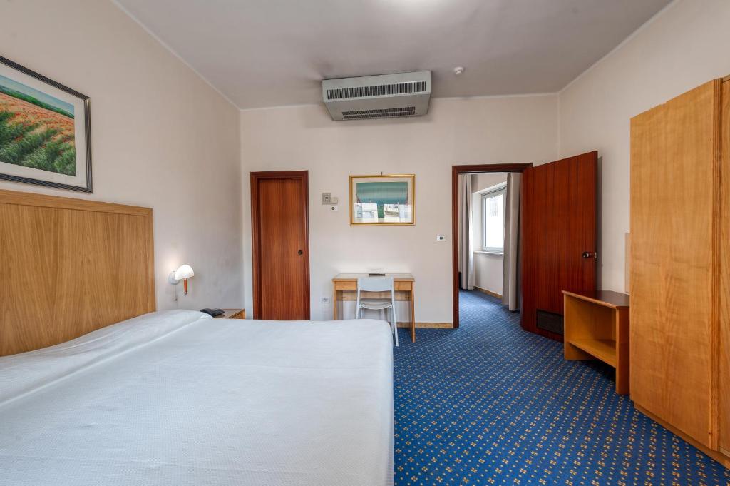Postel nebo postele na pokoji v ubytování Hotel Barsotti