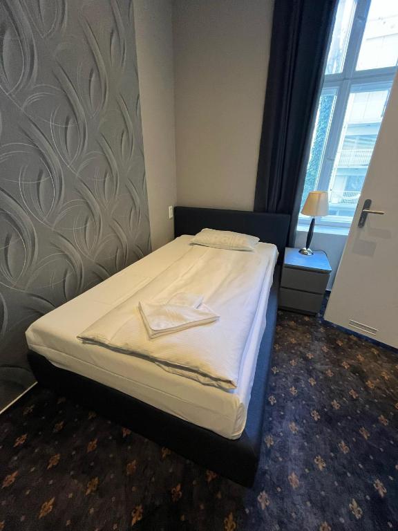 Postel nebo postele na pokoji v ubytování Hotel Gasteiner Hof
