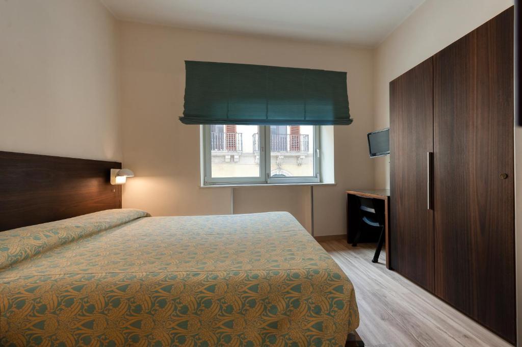 Postel nebo postele na pokoji v ubytování Hotel Barsotti