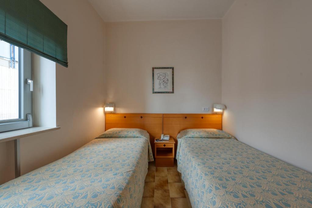 Postel nebo postele na pokoji v ubytování Hotel Barsotti