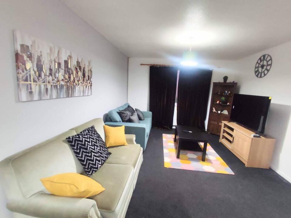 a living room with a couch and a television at Comfort Palace in Newcastle upon Tyne