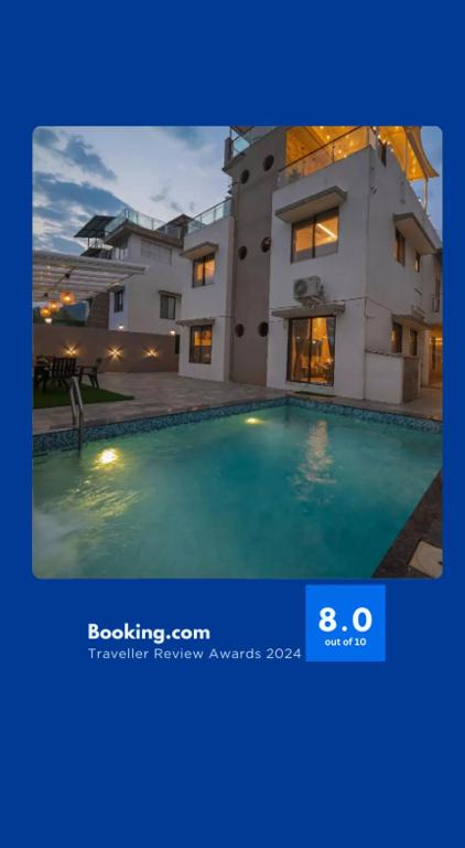 a picture of a house with a swimming pool at EKOSTAY - Ivana Villa in Lonavala