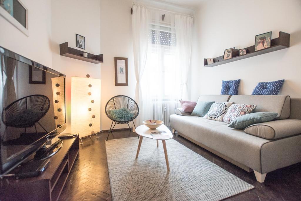 a living room with a couch and a tv at Cobalt Haven Apartment in Budapest