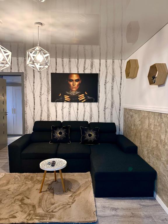 a living room with a couch and a table at GOLD Apartment - Tomis Nord in Constanţa