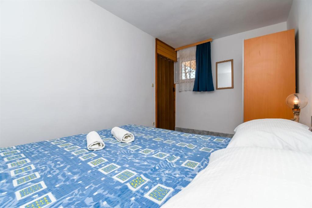 Posteľ alebo postele v izbe v ubytovaní Apartments Rose