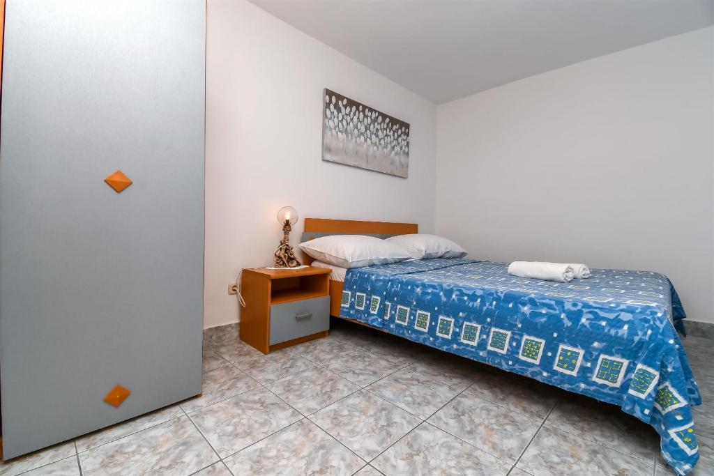 Posteľ alebo postele v izbe v ubytovaní Apartments Rose