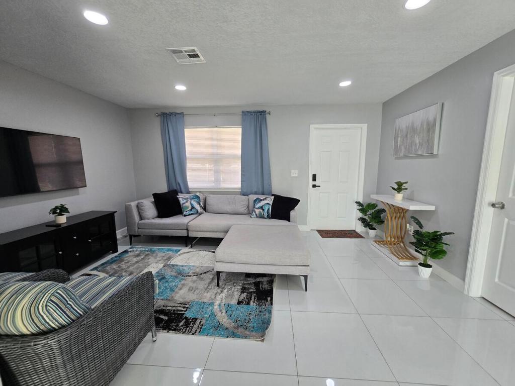 a living room with a couch and a table at Green Keys Ranch in Homestead