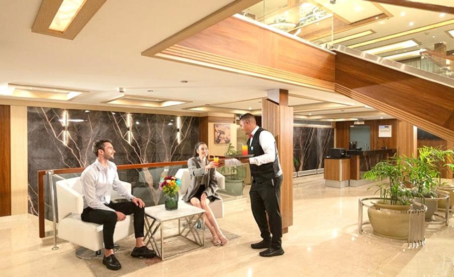 three people in a lobby with a man giving a woman something at Luxor Or Aswan Nile Cruise, Ultra Deluxe sailing 3, 4, Or 7 Nights in Luxor