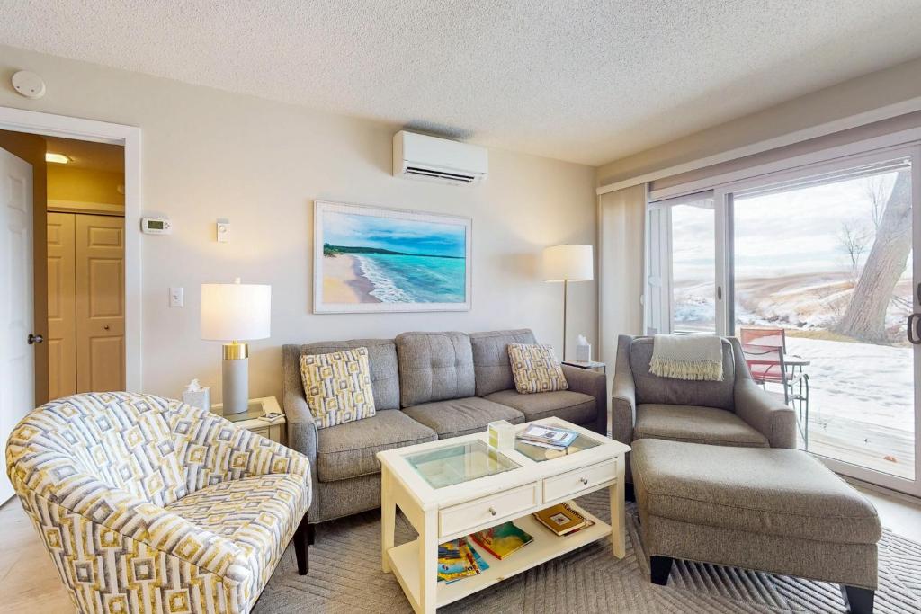 a living room with a couch and a chair at Great Lakes 11 in Glen Arbor