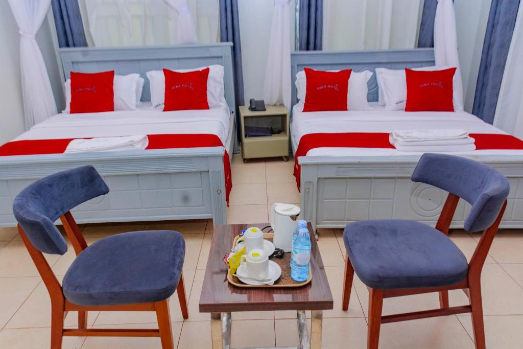 Postel nebo postele na pokoji v ubytování NIBA Hotel