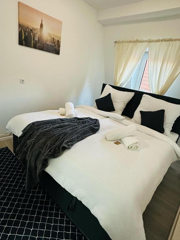 a bedroom with two beds with white sheets and a window at FEWO- Rafaelo2 in Marsberg